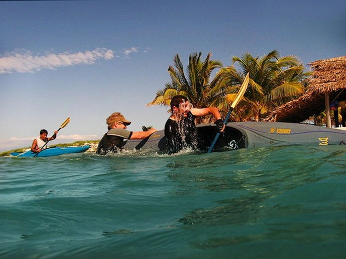 Slickrock Guests Learning Kayak Rolling in Belize at Glovers Reef Atoll